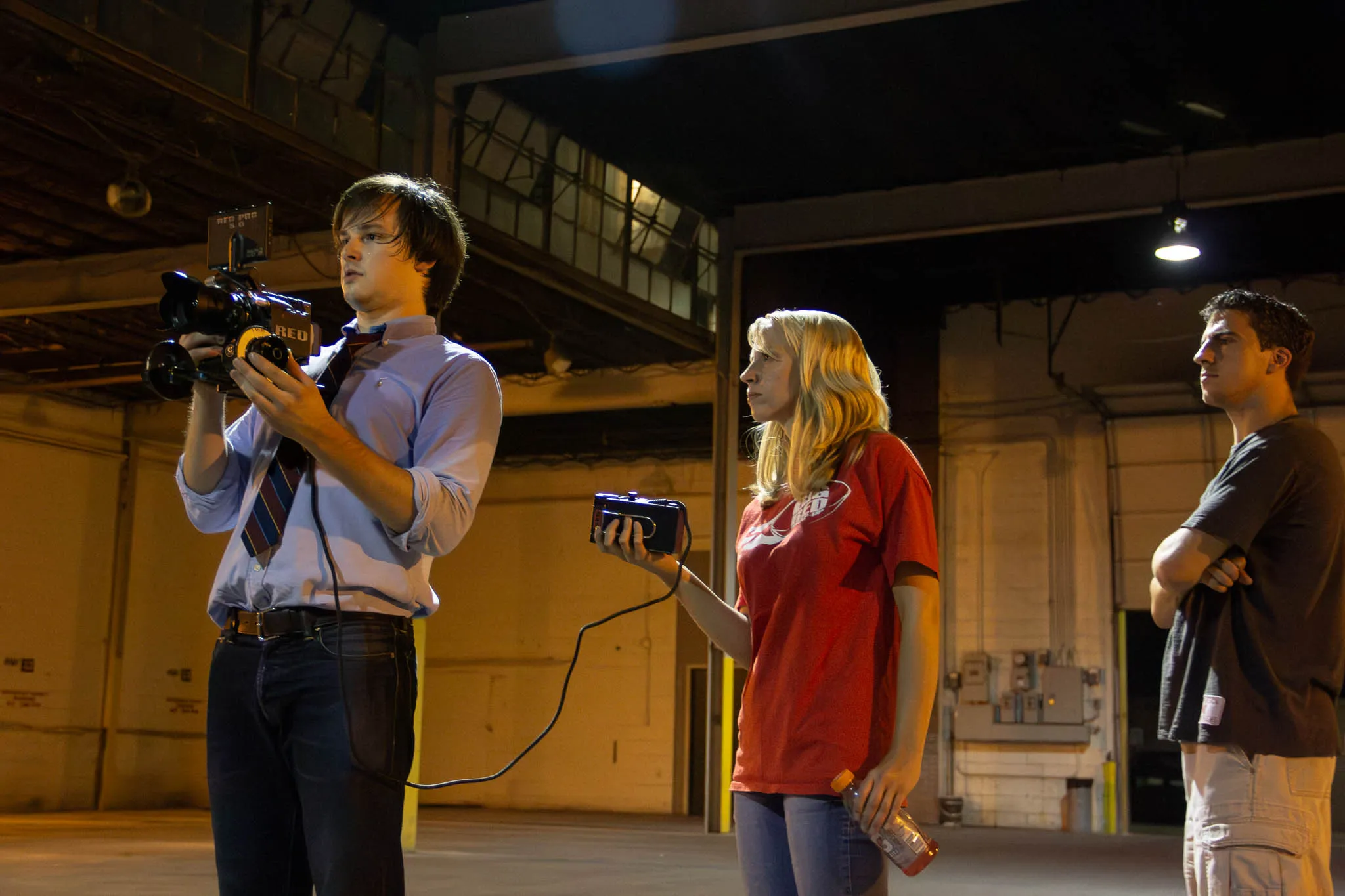 Alexander Jeffery composes a handheld shot while Emily Kreutz wrangles the battery. Our DOP Zach Janky continues to be photographed not touching the camera.