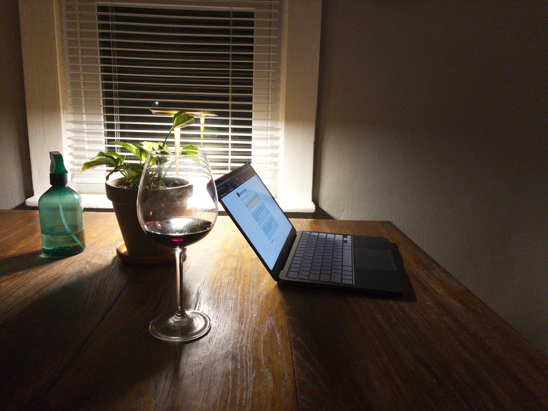 My MacBook Neo on the table with some wine.